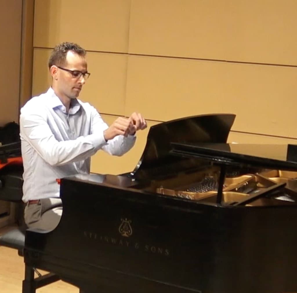 Greg Fiorentino at a Steinway and Sons grand piano in a recital hall